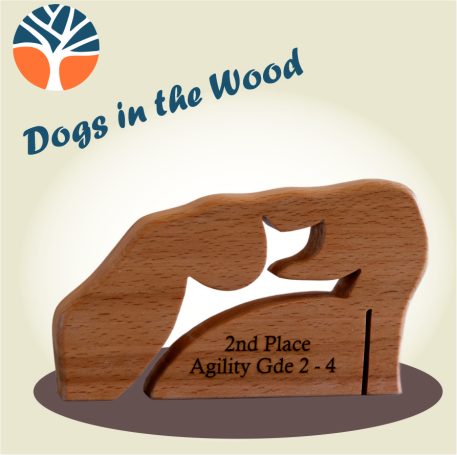 Wooden trophy cut from solid beech or oak with a stylised jumping agility dog cut through and engraved with your message.