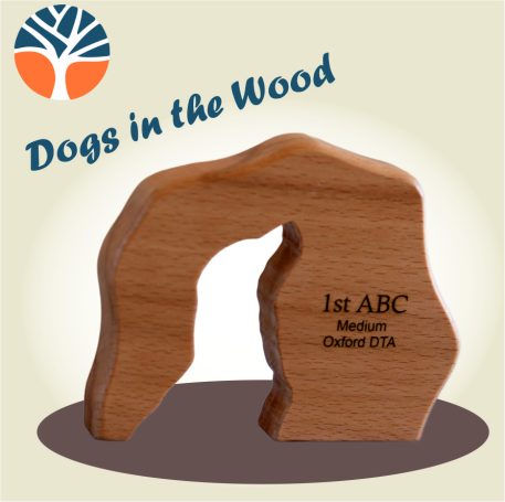 Wooden trophy cut from solid beech or oak with a silhouette of a dog's head cut through and engraved with your message.